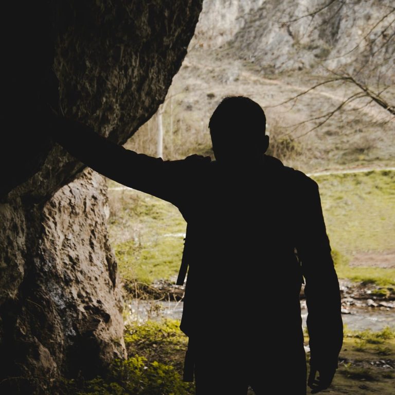silhouette-hiker-cave
